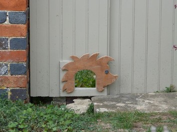 photo showing hole in fence for hedgehogs to use