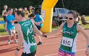 photo of Jacqueline Hall passing the baton to Andrew Bailey